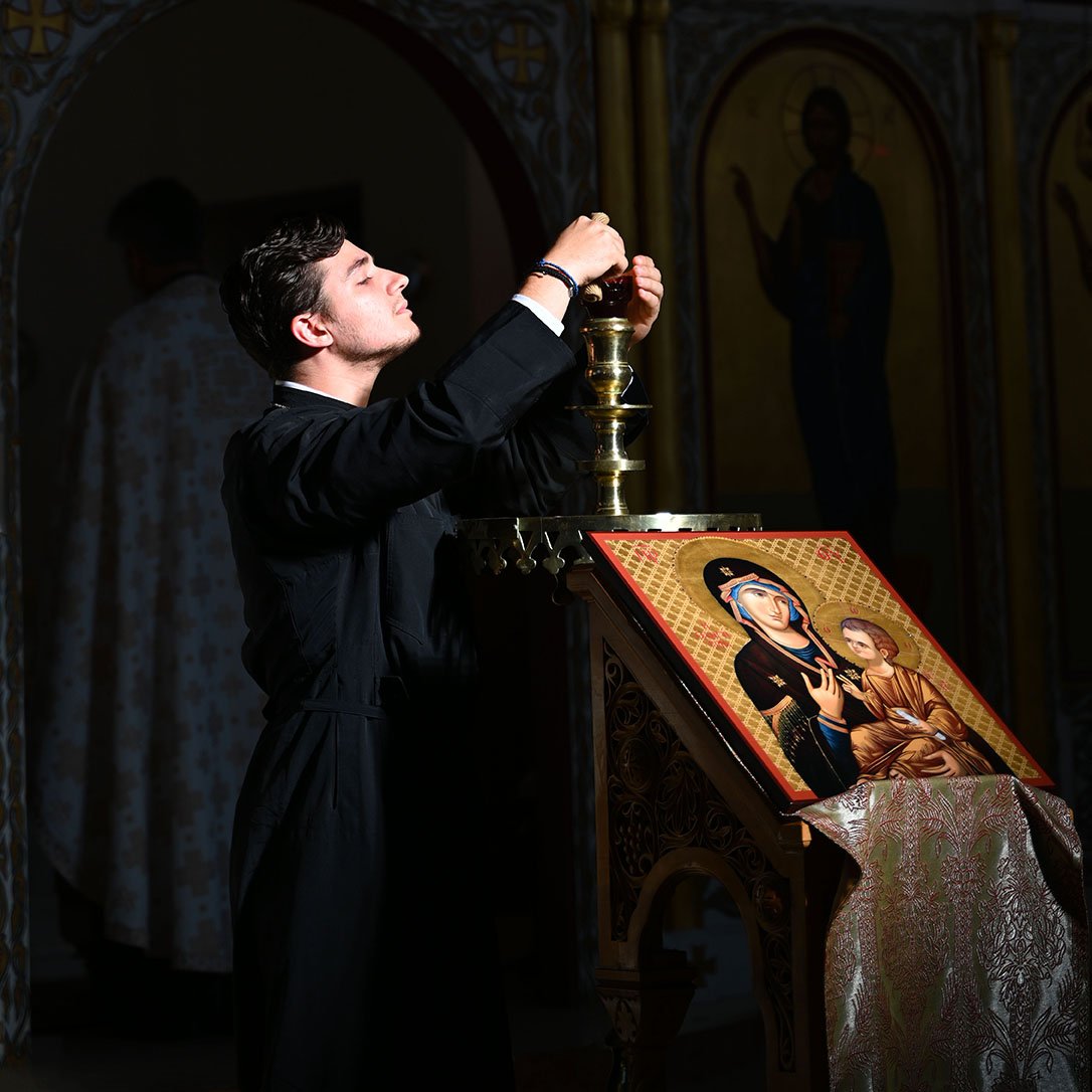 Seminarian lighting lamps at Vespers